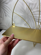 Auksinės spalvos lentyna su metaliniu rėmu